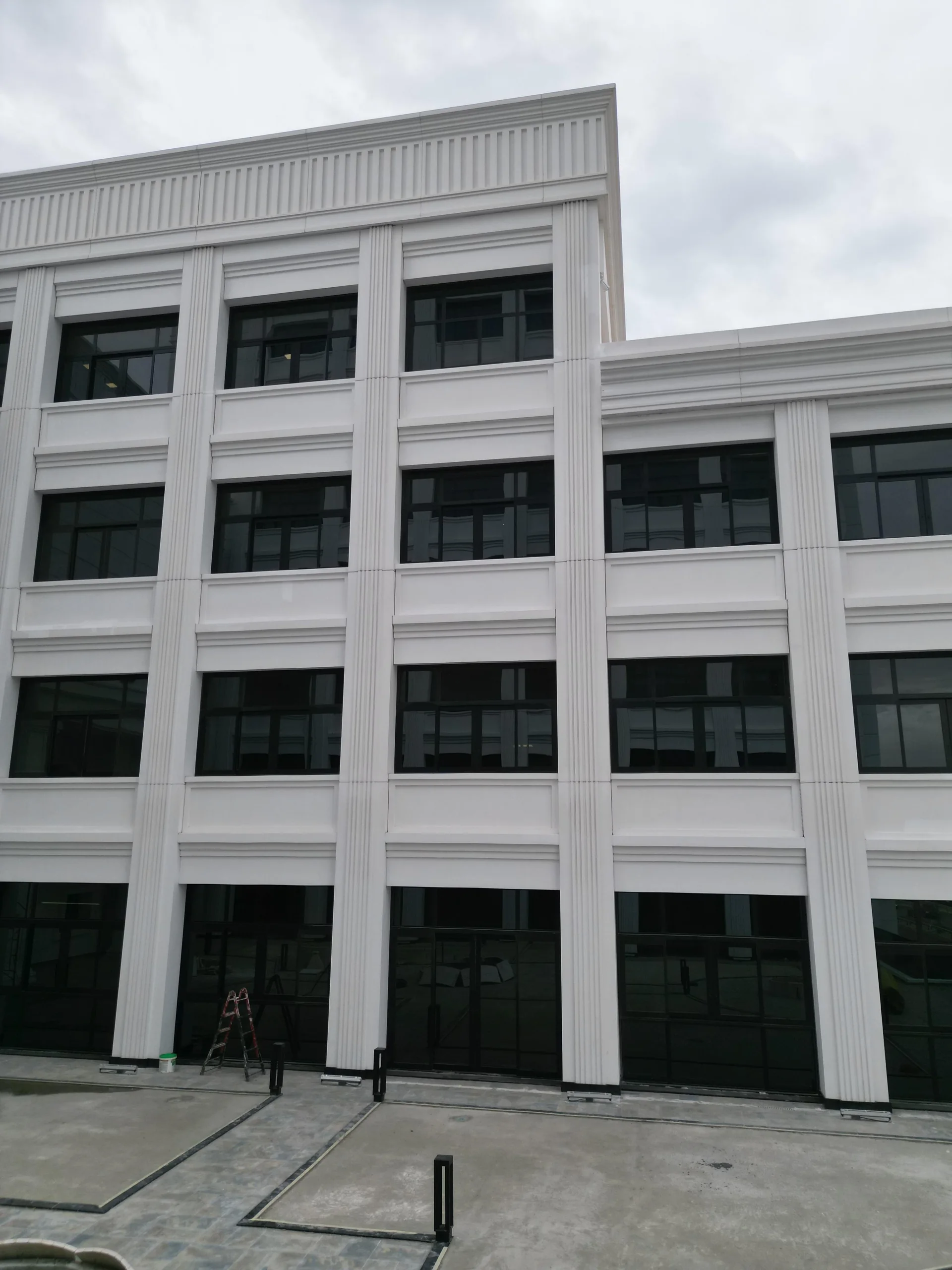 Courtyard elevation featuring fluted pilasters, classical cornices, and architectural glazing