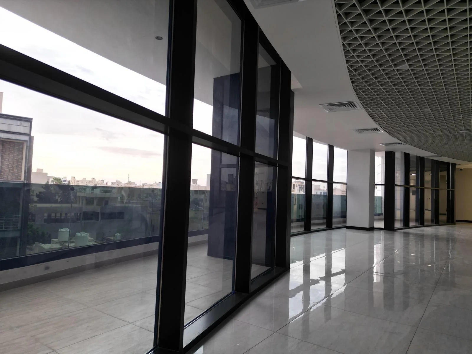 Panoramic glazed circulation hall and outdoor terrace transition